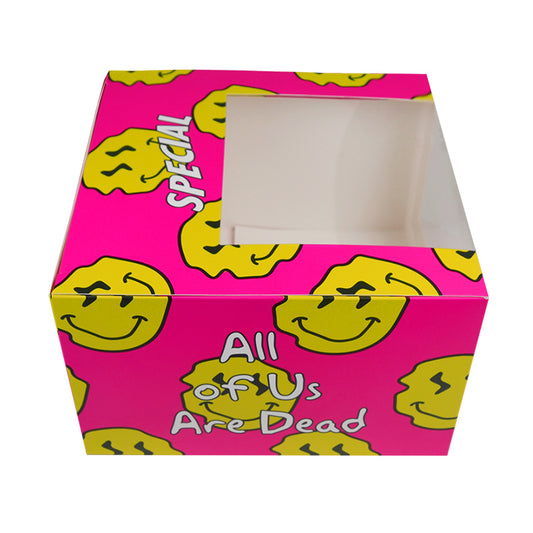 Pink cardboard food box with yellow smiley pattern and front window