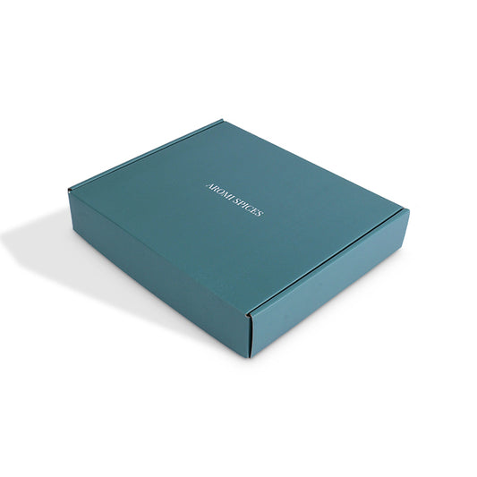 Teal blue mailer box with printed top panel and fold-over sides