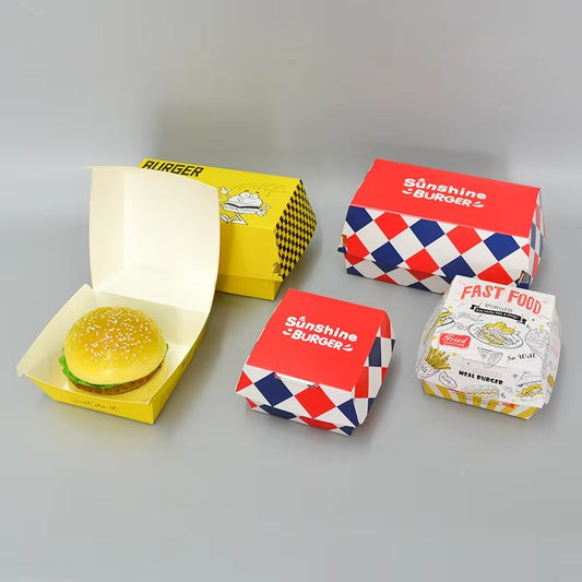 Fast food packaging set with red burger boxes and a wrapped snack food bag