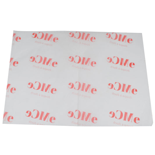 White tissue paper with red "Me" lettering repeat pattern