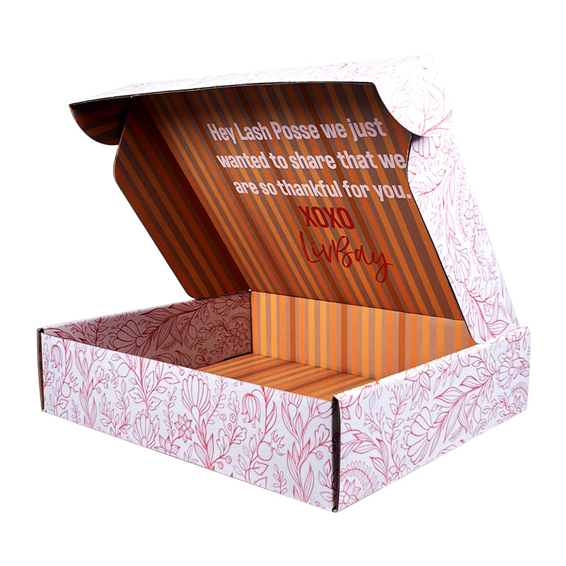 Mailer box with open lid, pink leaf-pattern exterior and striped interior