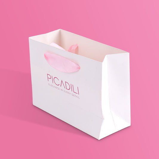 White paper tote bag with PICADILI logo and pink ribbon handle