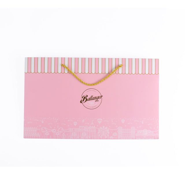 Pink rigid carrier bag with yellow rope handles and Ballanger logo on front.