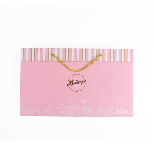Pink rigid carrier bag with yellow rope handles and Ballanger logo on front.