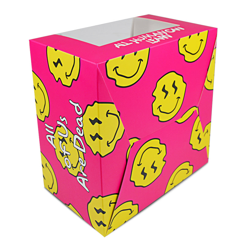 Pink cardboard food box with yellow smiley pattern and visible side panel text