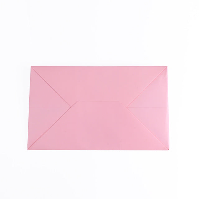 Pink rigid carrier bag with angled fold panels and flat rectangular shape.