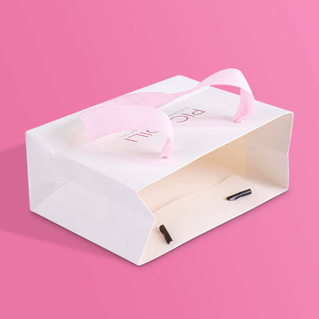 White paper tote bag with pink tissue and PICADILI branding, open lid