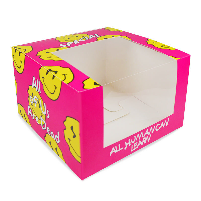 Pink cardboard food box with yellow smiley pattern and open top window