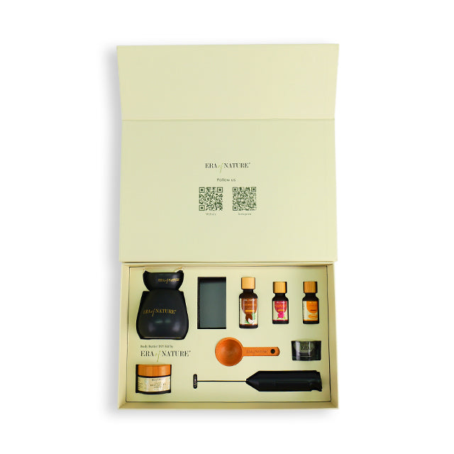 Light green magnetic flap rigid gift box opened, revealing bottles and tools in tray.