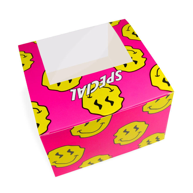 Pink cardboard food box with yellow smiley pattern and open top window