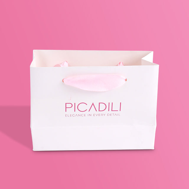 White paper tote bag front view with pink ribbon handle and PICADILI logo