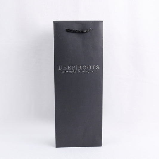 Black paper wine gift bag with top rope handle and 'DEEP ROOTS' logo on front