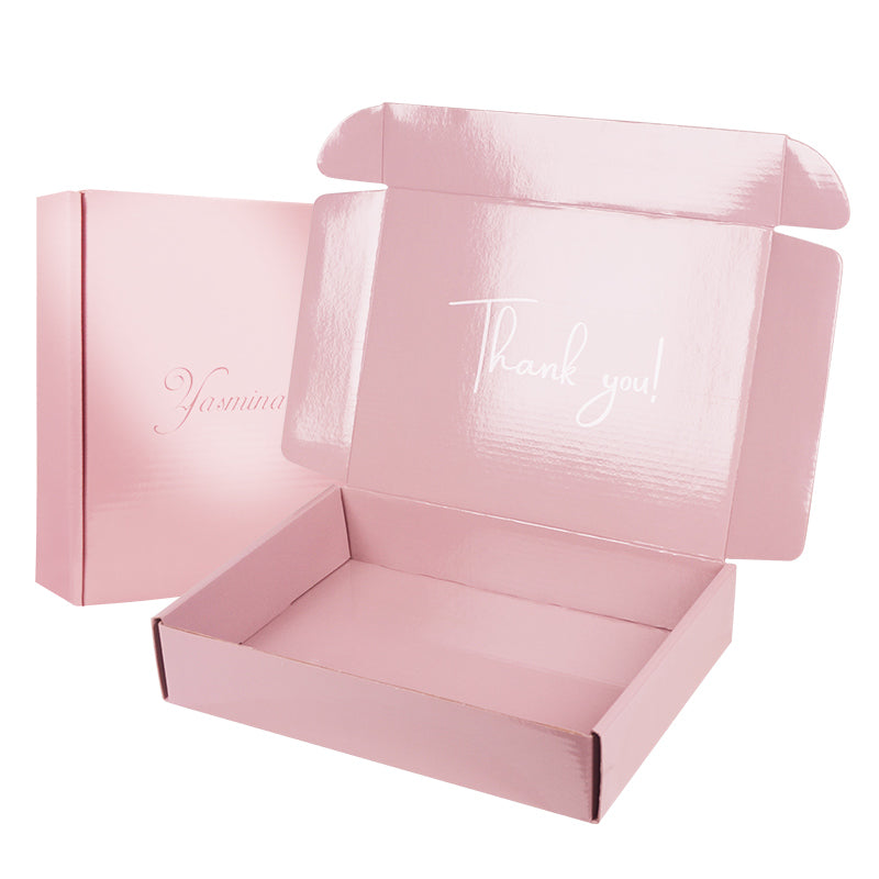 Open pink brand box showing interior "Thank you!" message with closed box behind