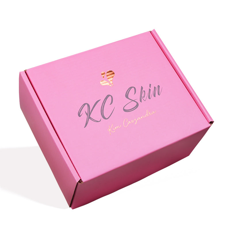 Closed custom pink folding mailer box with rose gold KC Skin logo for cosmetics shipping