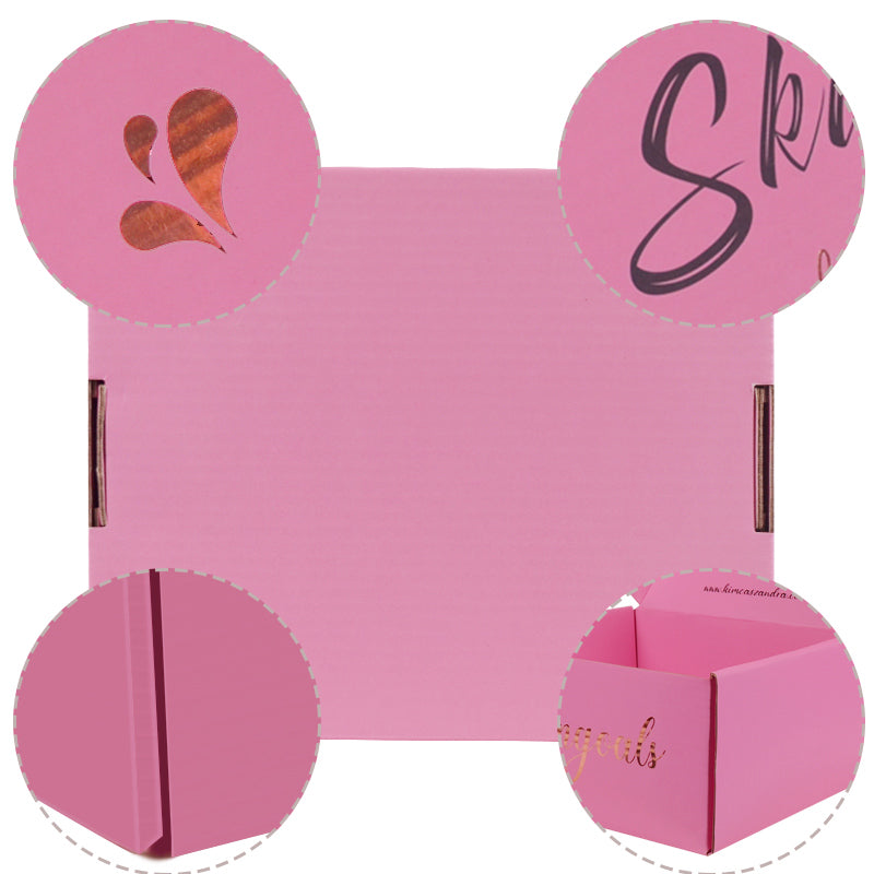 Pink one-piece foldable mailer box with foil branding, die-cut details, and interior message