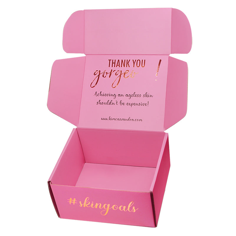 Open pink mailer box showing interior "Thank You Gorgeous" brand message
