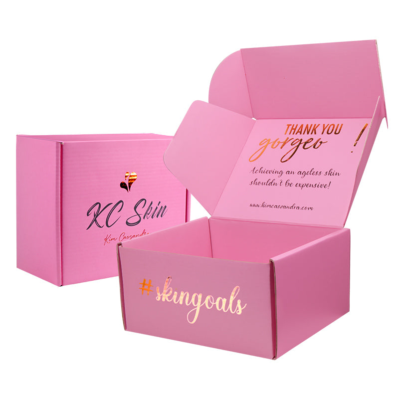 Angled view of custom pink folding carton with handwritten Kim Cassandra logo