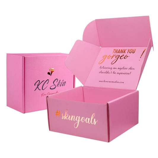 Angled view of custom pink folding carton with handwritten Kim Cassandra logo