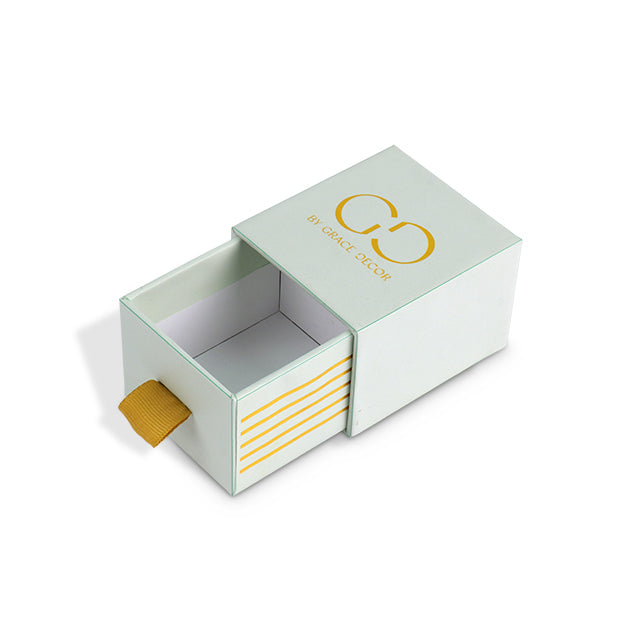 Internal view of empty custom drawer box showing the golden ribbon pull tab