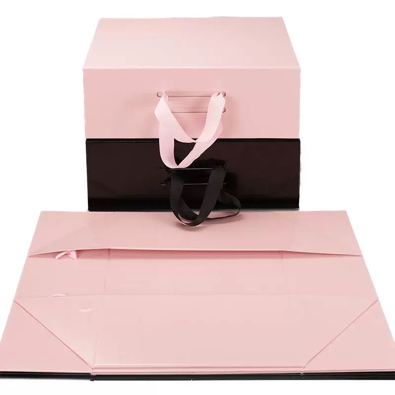 Pink foldable gift box with ribbon handle, with matching bottom tray expanded