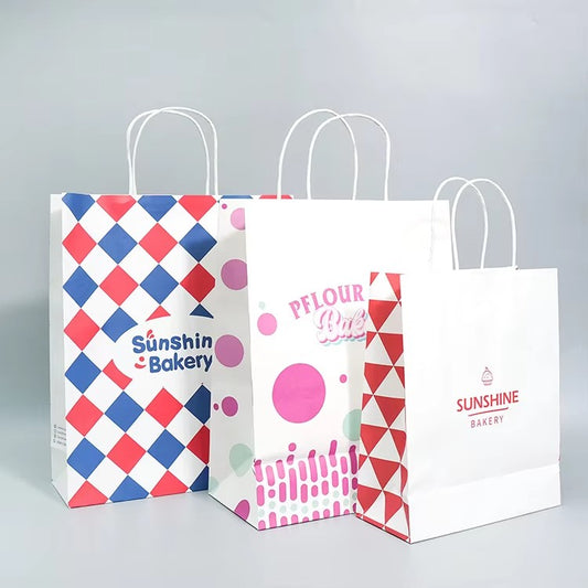 Printed bakery paper bags with white handles; blue red diamond and pink logo designs