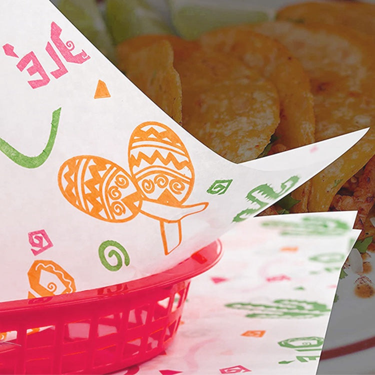 Greaseproof wax paper with colorful Easter icons, layered sheets over baked food