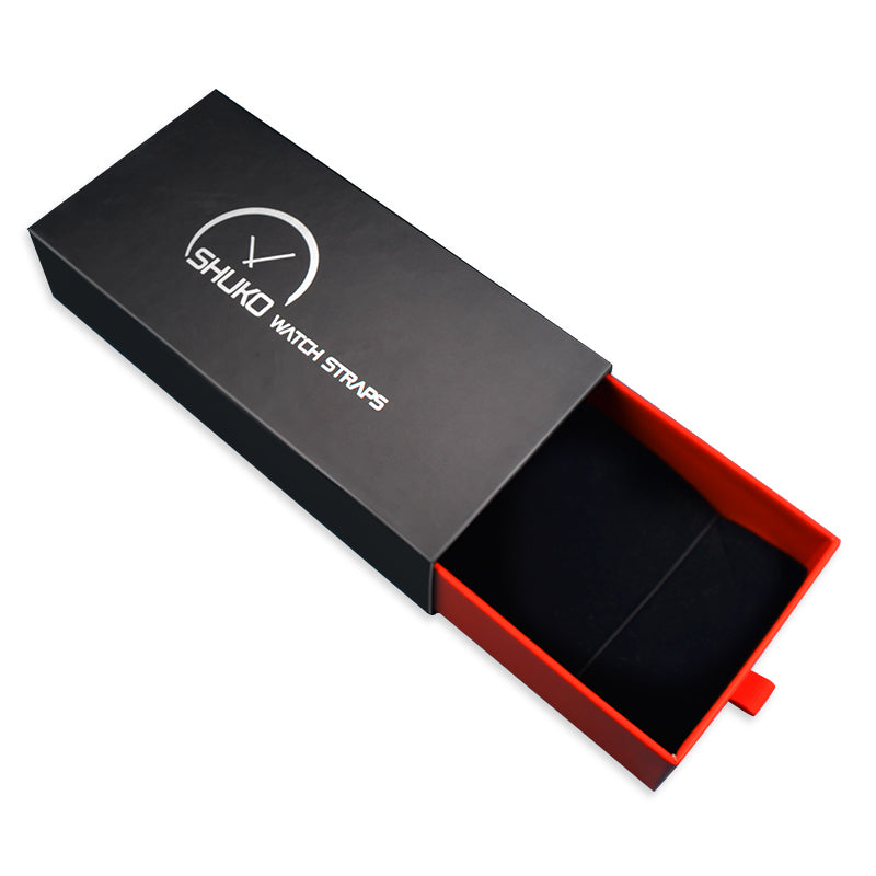 Open drawer box displaying black cover and red base revealing empty inner space for watch strap