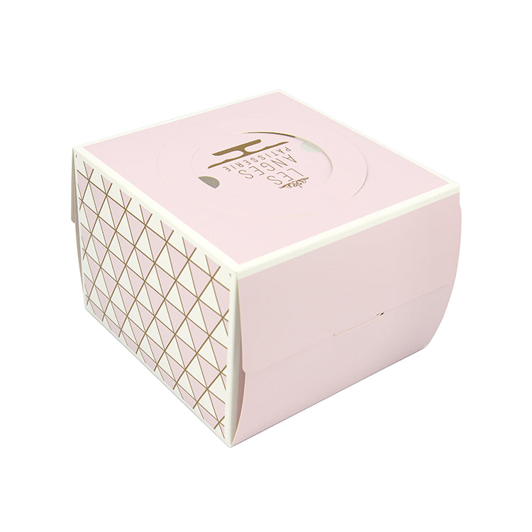 Pink cake box with gold geometric side pattern and gold logo on lid