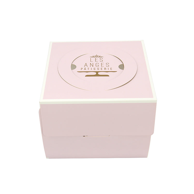 Pink rectangular cake box with gold logo on lid and vented-style top
