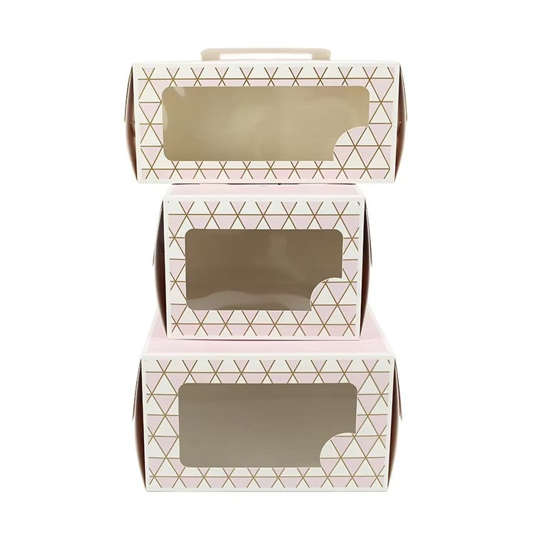 Pink cake box with gold geometric window, top handle, vented lid