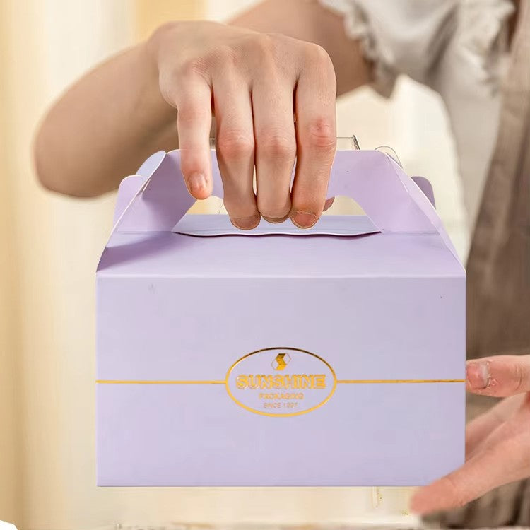 Purple cake box with handle, 'SUNSHINE' logo on front