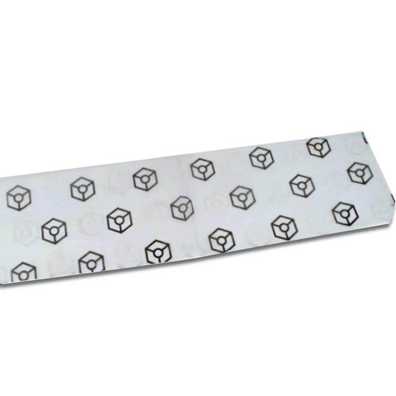 Long strip of tissue paper with repeating black hexagon cube logo pattern