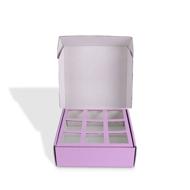 Top-down view of open purple mailer box with empty 9-grid insert for donuts