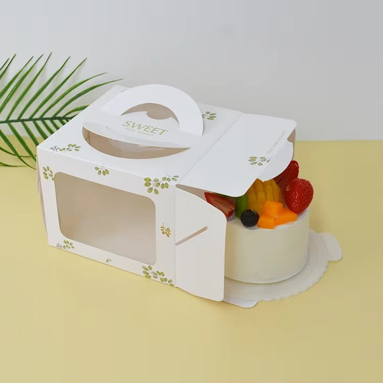 White cake box with handle and clear window, small green leaf print